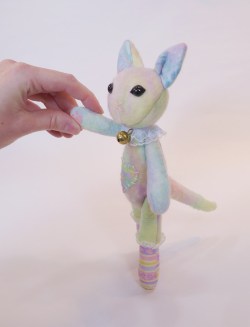 lithefidercreatures:  This jointed cat cutie is now for sale in my shop.  :)  Made with mostly my own handmade wool felt, which is how she is such a mottled rainbow color.  It is stiffer then the more cuddly felted sweater style, but I like the feel
