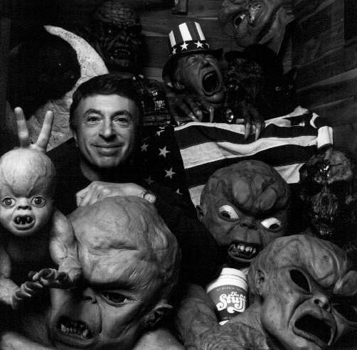 Larry Cohen posing with models of the 'child' from It's Alive