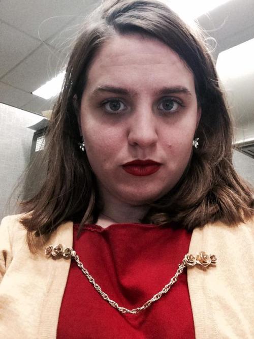 cpshoes:[Image description: A white woman with brown hair and red lips wears a red dress with a yell