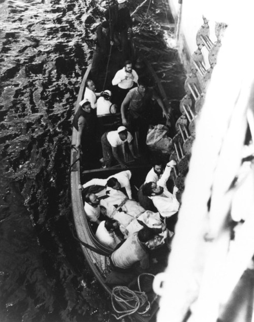 Captured German crew members of the submarine U-505 climb aboard the American escort carrier USS Gua