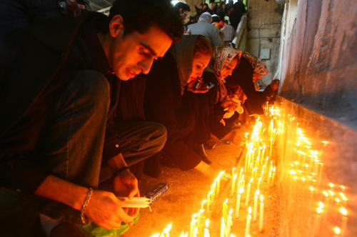 Members of Iran’s Jewish community light candles as they pray at the Tomb of Daniel in Shush (ancien