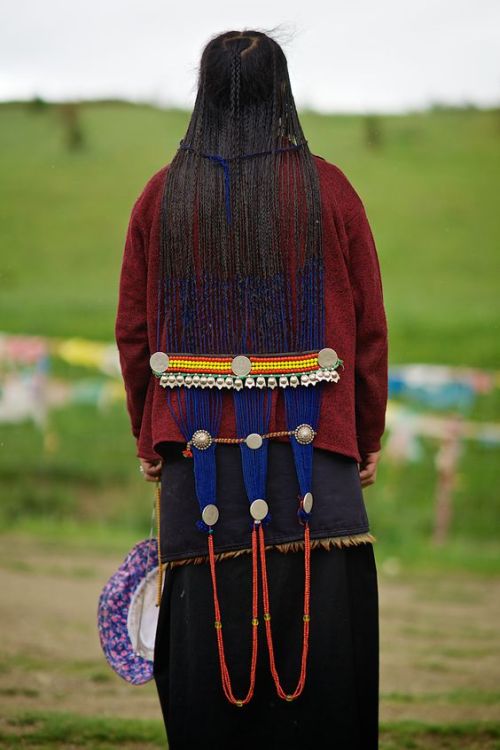 Tibetan woman pilgrim posing around Chode Monastery, Kham, Litang, Tibet by Axel Saurel