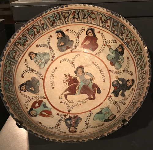 Ceramic bowl from the Persian city of Kashan, depicting seated figures, a horseman, and Mesopotamian