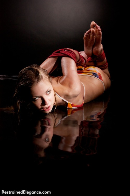 Beautiful Lilith, Hogtied with elbows tightly together in a shallow pool of water that forces her to