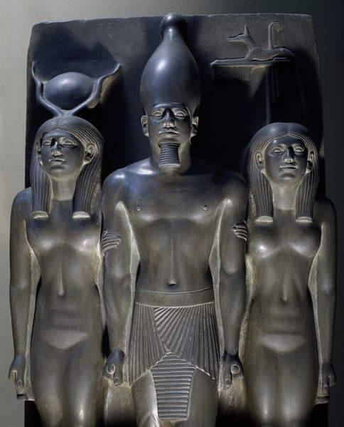 Triad of MenkaureThe king accompanied by Hathor and a Nome Goddess with the crouching jackal emblem 