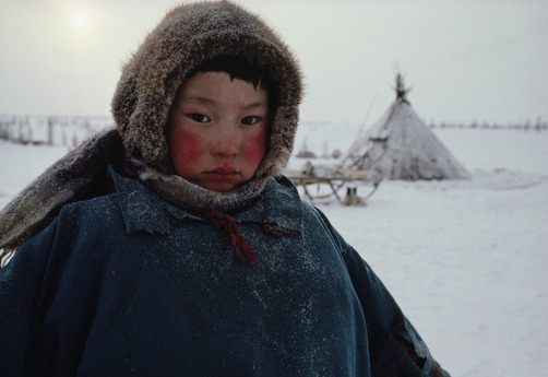 unrar:  A young Nentsy boy stands in the sub-zero Arctic cold near his home, Siberian