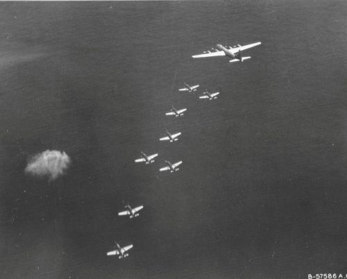 usaac-official:45th Fighter Squadron P-51s escort a 498th Bomb Group B-29 towards Japan, April 1945