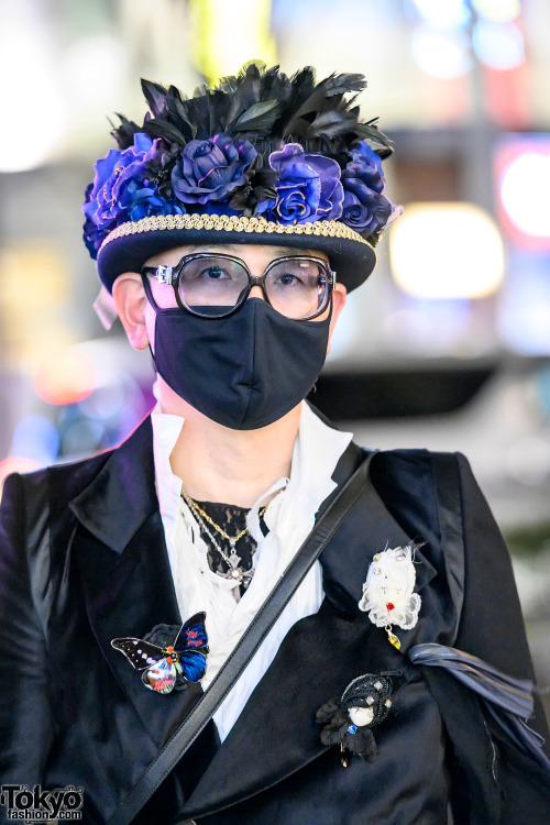 Japanese civil engineer Daishi on the street in Harajuku. His look includes a floral hat, long blaze