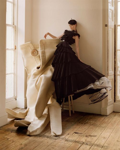 Coco Rocha, wearing a silk and cotton gown by Giles and a feather beret by Stephen Jones, with photo