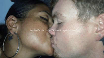 kissingchannel:  Danny and Nikki are seated on the couch engaged in some lip locking