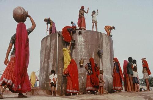 dolm: Women and children collecting water from the village tank. 1991, Bhagatashni, Rajasthan, India