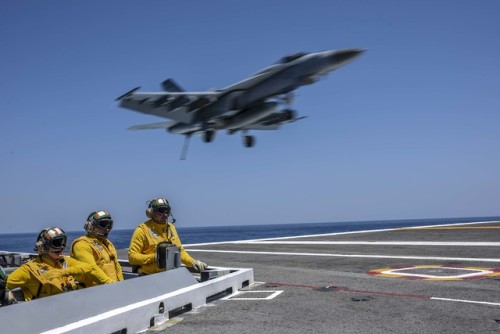 Flight OperationsSailors observe flight operations as an F/A-18E Super Hornet assigned to Strike Fig