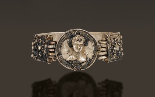 ancientjewels:Hellenistic period Greek silver bracelet depicting a bust of Dionysos and grape vines,