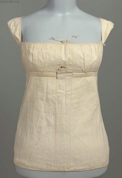 A corset from the 1810s. You can see that it has almost no boning or shaping, merely supporting the 