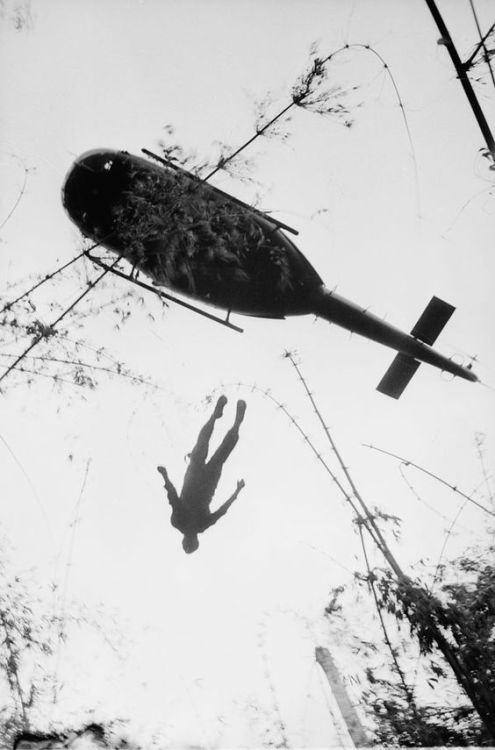 the body of an american paratrooper killed in action is airlifted out of the war zone 1966 vietnam w