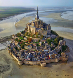 dailyoverview: Check out this incredible shot of Mont St. Michel in Normandy, France. Over the past 600 years, the island has functioned as a prominent monastery (accessible to pilgrims only during low tide), a French military fortification, and a prison.