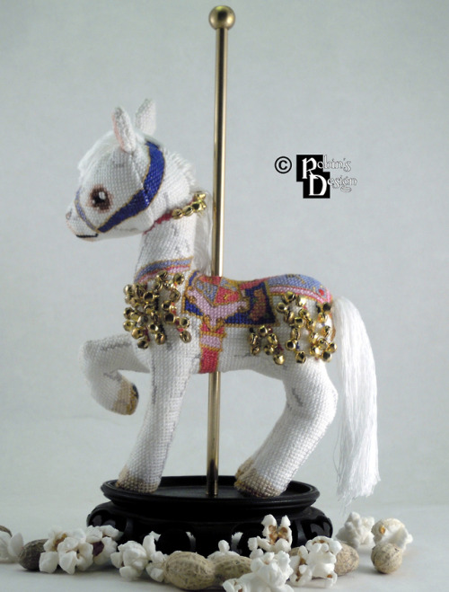 The bells, the bells! I sewed over 100 of them onto this 3d cross stitched carousel horse, but I thi