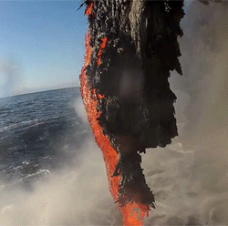 onlylolgifs:  Lava spilling into the ocean 