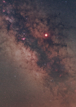 sci-universe:  Galactic Moon eclipse captured by Babak Tafreshi. Take time to look at this image, and you’ll notice several large emission nebulae with vivid red color, details of the Milky Way and lots of stars. 