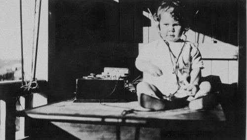  Young child listening to a radio, ca. 1925