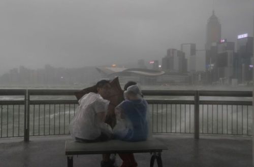  People play with strong wind caused by Typhoon Hato on the waterfront of Victoria Habour in Hong Ko