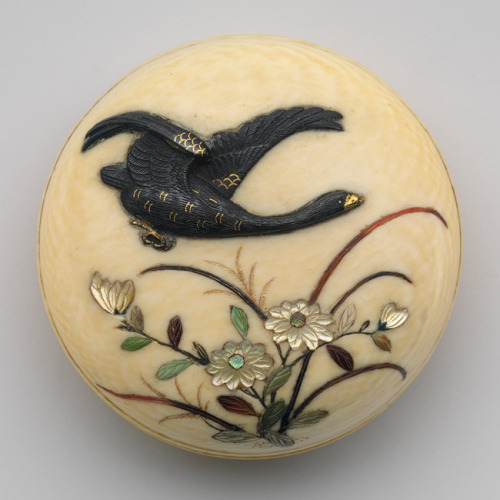 Netsuke of Flying Goose over flowers, 19th century JapaneseIvory, metal alloy, mother–of–pearl, tort
