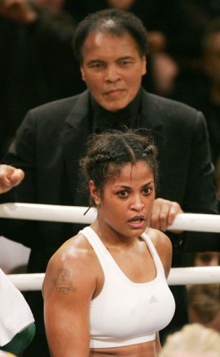 vivid-mindedempress:  kingpinnn:  U.S. boxing legend Muhammad Ali (top) smiles as he stands behind his Daughter Laila Ali, after her super-middleweight fight against Asa Sandell of Sweden in Berlin December 17, 2005  Love Strong Black Women.