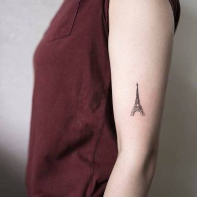 Fine line Eiffel Tower tattoo on the wrist