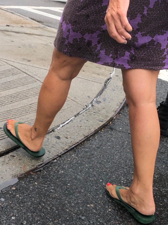 Ladylike candid with nice legs walking in the street