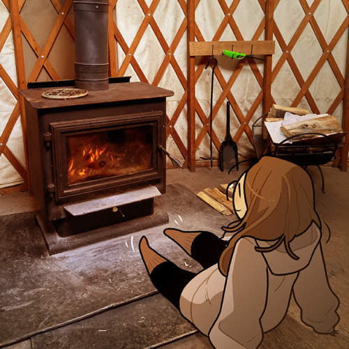 Description: A photo of a wood burning stove.  An illustration of myself sits on the ground in 