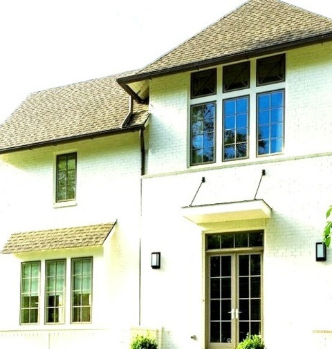 Exterior Brick AtlantaHip Roof On A Sizable Transitional White Three-story Brick Exterior Home.
