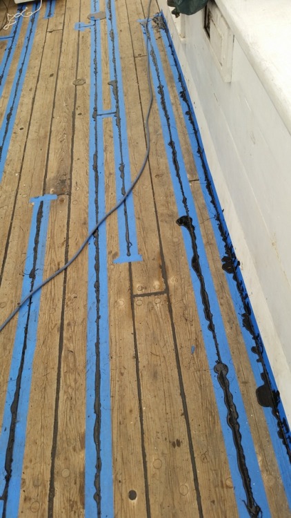 Removing excess tar used to seal caulking.