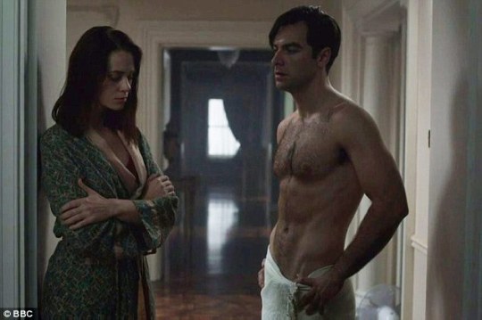 Woman in a bathrobe, man in a towel slung very low across his hips