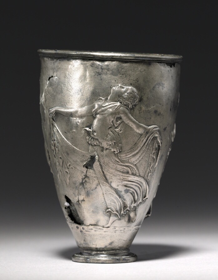 via-appia:  The Vicarello Goblet: woman at the shrine of the god Priapus, maenad