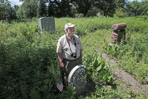 Dave Daley, a member of the Sons Of Union Veterans, stands next to the grave of Homer Clark, a lieut