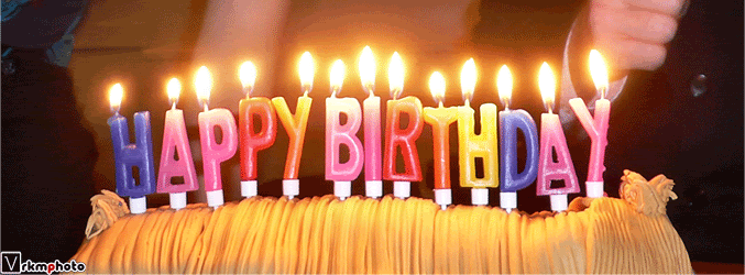 Burn Baby Burn Human hands set fire to candles on beautiful delicious birthday cake that is on kitchen table. burn baby burn