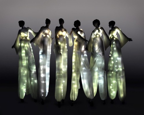 A theatrical troupe of glowing stilt walkers.