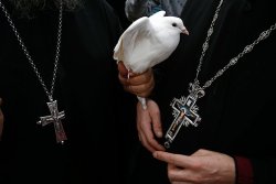 globalchristendom:Greek Orthodox clergy with a dove in Jericho, West Bank. (Credit: Baz Ratner - Reuters)