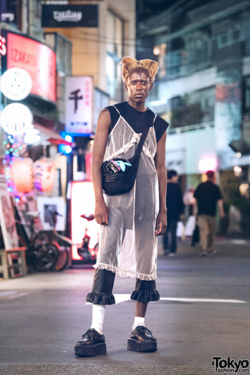 Zelig Wilson on the street in Harajuku at night. His look - including items from J.W. Anderson, H&am
