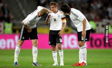 Germany's central defenders (6'4 and 6'6) bending down to talk to their captain (5'6)