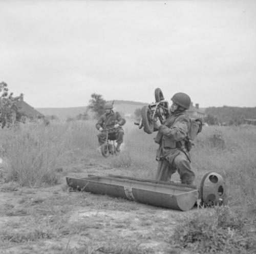 historicaltimes:British paratroopers retrieve folding motorcycles or ‘Welbikes’ from equipment conta