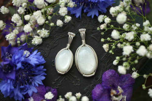 Close up of velvet like white moonstone pendants in sterling silver. They’re available at my E