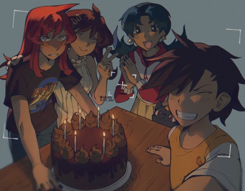 Selfie of silver, blue, crystal, sneasel and gold standing around a wooden table with a birthday cake. Silver is wearing a proteam omega shirt, blue is holding silvers shoulder and making a peace sign, crystal is standing next to sneasel who is trying to peek over the table. Gold is holding the camera. All of them (except sneasel) are smiling at the camera.