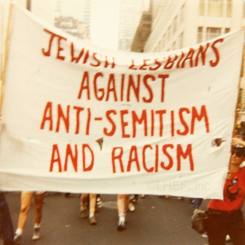 h-e-r-s-t-o-r-y:Jewish Lesbians Against Anti-Semitism and Racism. Banner in pride march, NYC. 1970s.