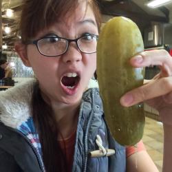 Hot Asian girl sucking on a huge pickle.