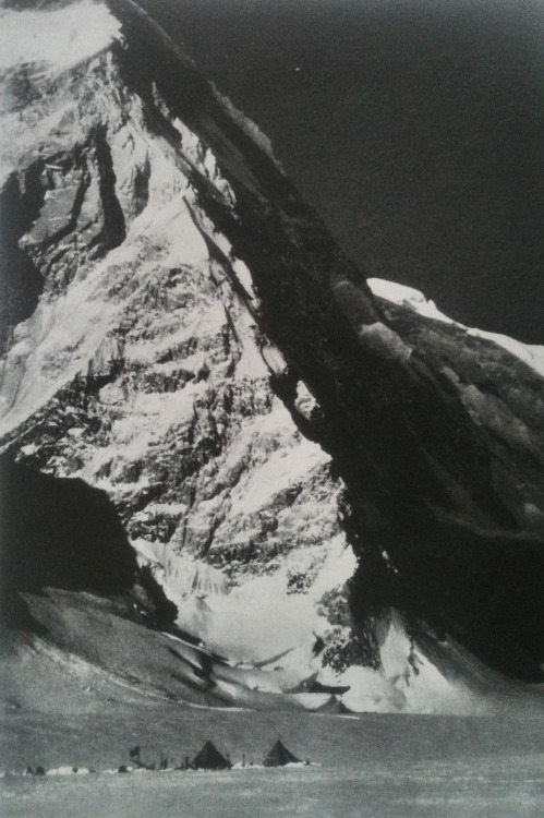 justenoughisplenty:  Rocky north face of Mount Kennedy dwarfs campers in Lowell Glacier. National Geographic - July, 1965 