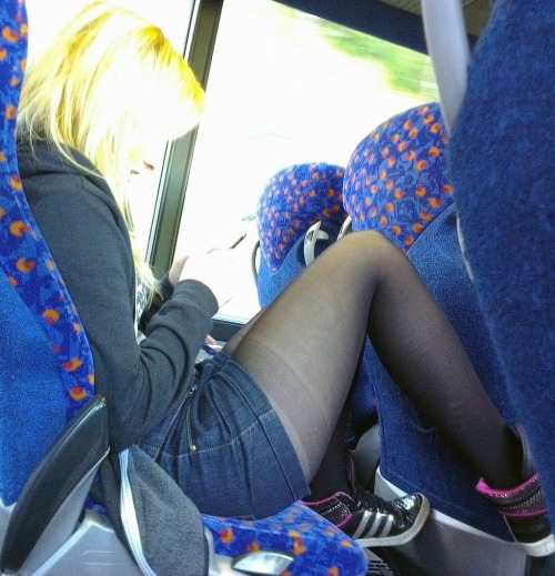 Candid black pantyhose with shorts on a train.Legs in pantyhose