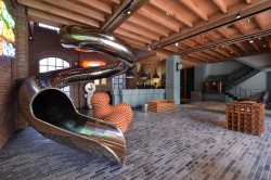 stylish-homes:  Lobby of the RedDot Hotel in Taiwan features a 27m stainless steel tube slide descending from the second floor. via reddit Keep reading