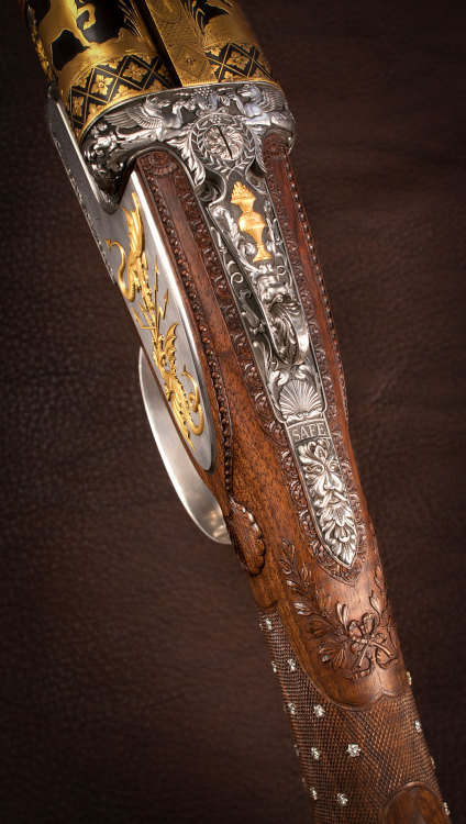 A very ornate 12 gauge double barrel shotgun decorated in the style of 19th century gunmaker Nicolas