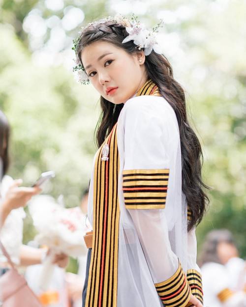 University student from Thailand wearing a special down used for graduation and reception of diploma